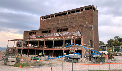 The graffiti-covered Moran Plant as construction vehicles begin rehabilitating the site.