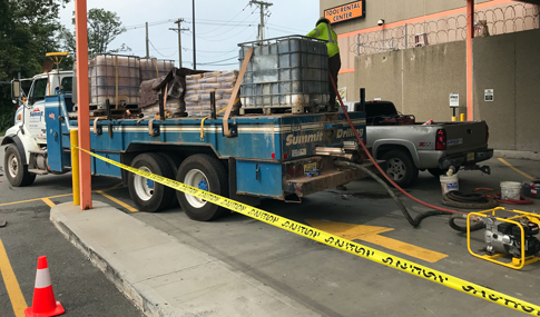 Licensed drillers performing grouting operations to seal former production wells.