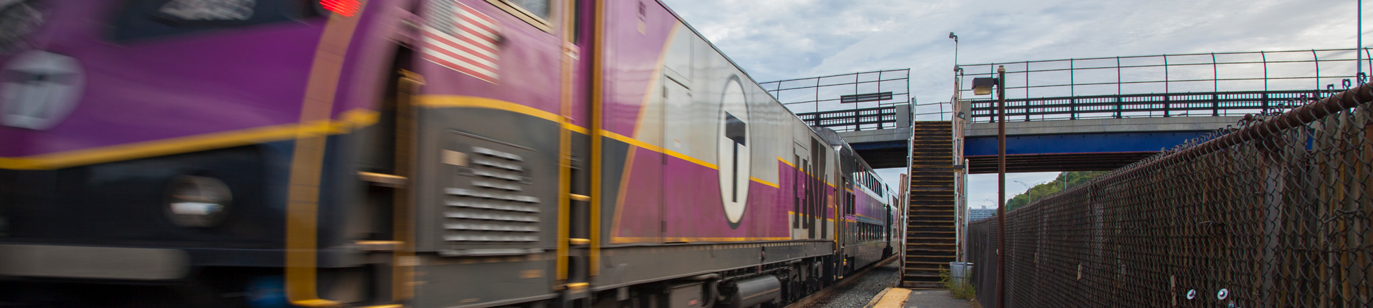 An MBTA Commuter Rail train pulls into a station.