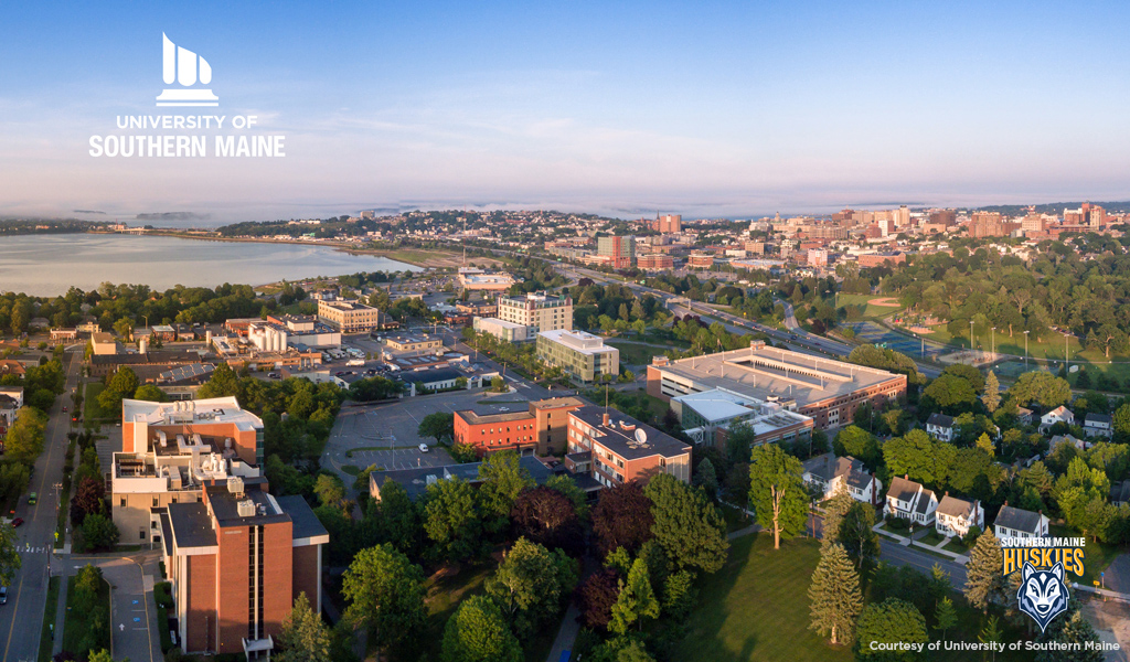 Aerial photo of University of Southern Maine at dusk with watermark and logo.