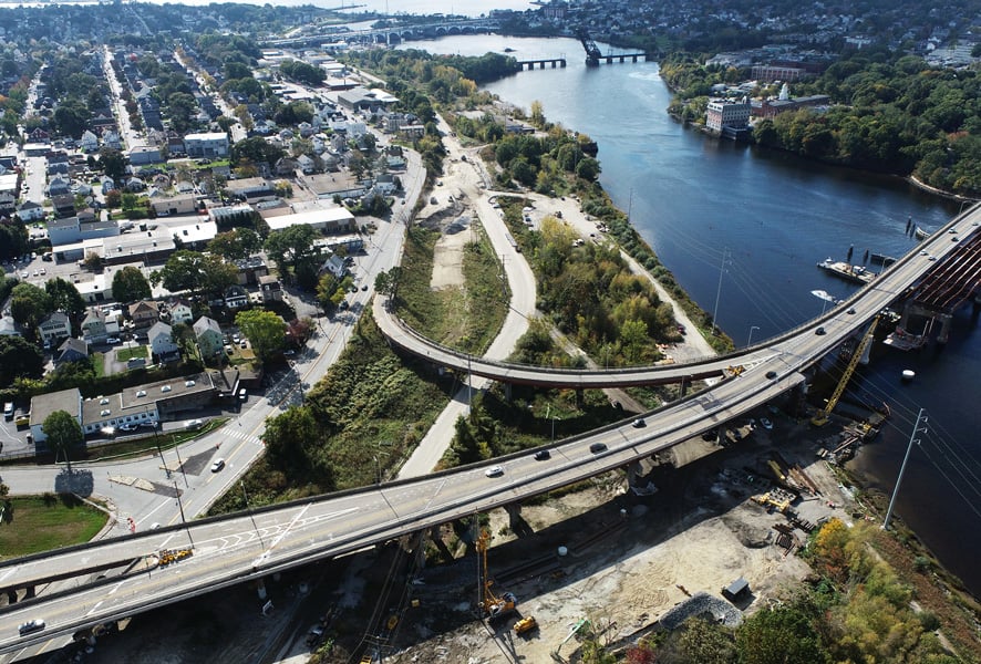 An aerial view of a bridge being constructed over water. 