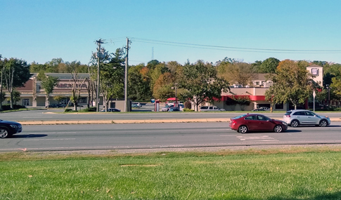 The corner of the Village Lake Drive intersection with numerous cars. 