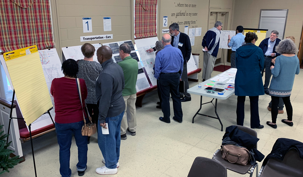 Attendees at a Midtown St. Albans public meeting review and discuss transportation information with project team.