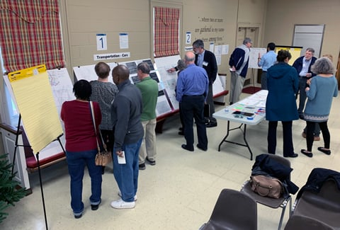 Attendees at a Midtown St. Albans public meeting review and discuss transportation information with project team.