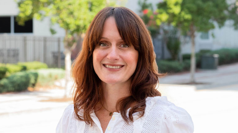 Katie Shannon smiling in a green shirt