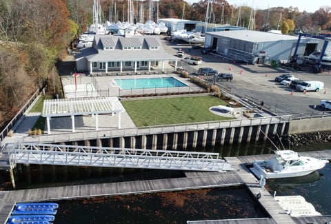 The reimagined marina features a pool house, pool, splash pad, open lawn, grilling spaces, and improved waterfront access.