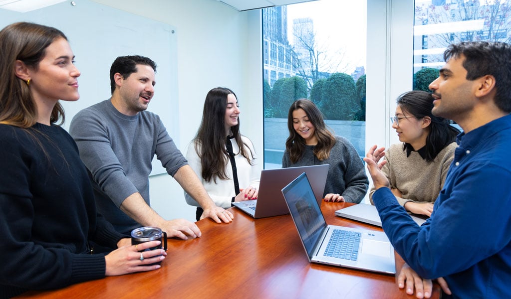 Young adults chatting and working together.