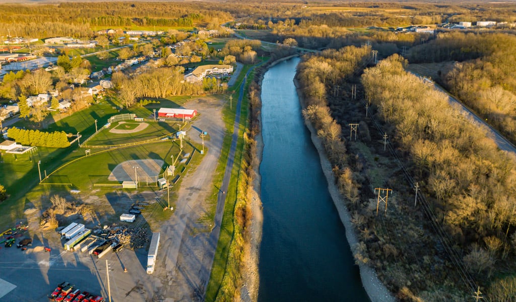 An aerial photo of Wayne County, NY, featuring a river, trees, and recreational space.