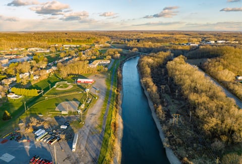 An aerial photo of Wayne County, NY, featuring a river, trees, and recreational space.