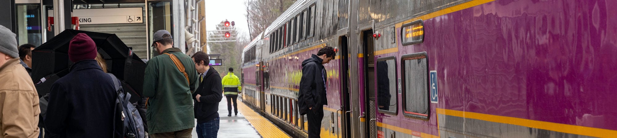 An MBTA train at a passenger rail station.