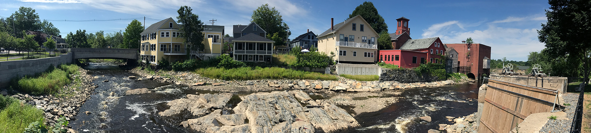 A free-flowing stream near four houses.