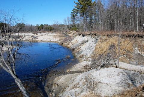 Aerial view of the Suncook River channel winding through forest and open land.