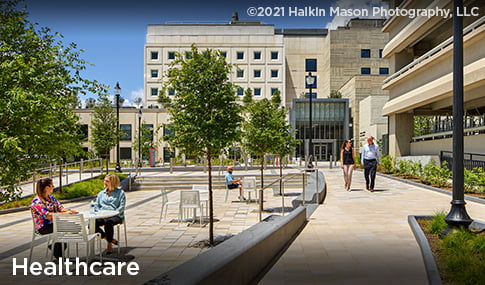 People sit and walk on the campus of Children’s National Research and Innovation Campus.