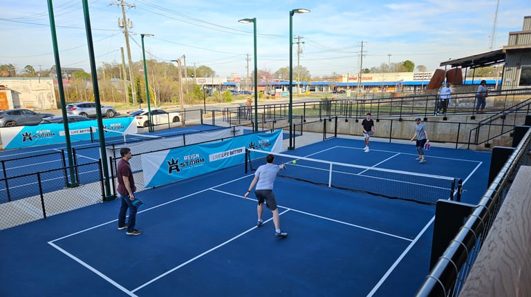 Charlotte office team members play pickleball during a tournament.