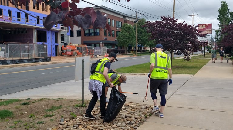 Members of the Charlotte Green Team pick up trash.