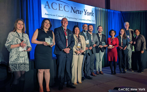 Alex Moscovitz, third from the right, holding the ACEC New York DEI+B Award in a group photo.