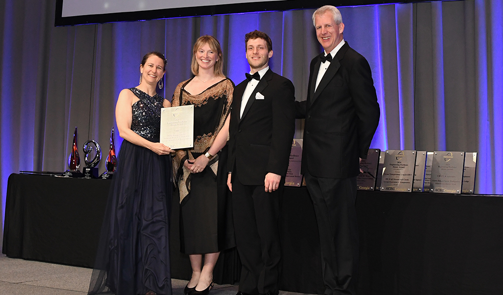 A group of people in formal wear on a stage