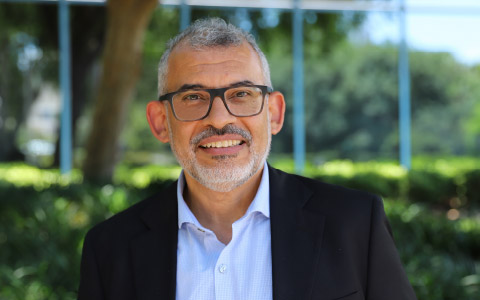 Amr El-Agroudy is wearing glasses and a business jacket