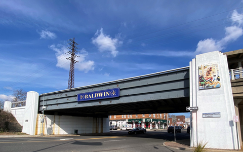 Blue and gold sign welcoming visitors to downtown Baldwin, Long Island.