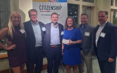 Tom Jackmin, Mark Junghans, Kathleen Keen, Brianne Belschner, Rob Nagi, and Matt Kealey accept a Boston Business Journal award.