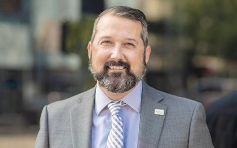 Ben Siwinski in a gray suit and lavender business shirt