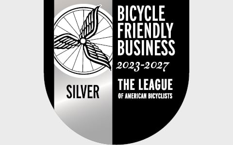 A black and white banner announcing the bicycle friendly business award
