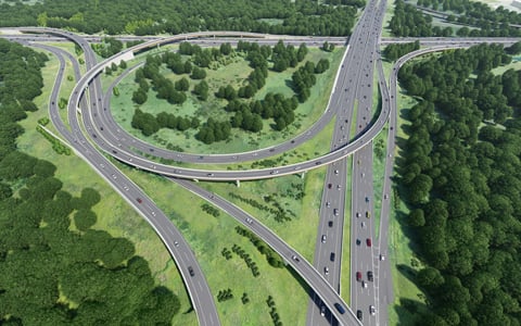 Cars driving on a model of a highway with overpasses.