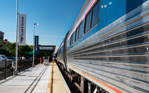Amtrak train on track with passenger platform.