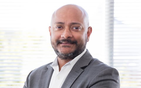 Chris smiles at the camera.