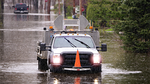 Image of a emergency truck on a flooded city street 