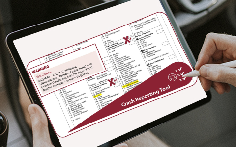 A person using a tablet that contains the fillable crash reporting tool document that contains crash details.
