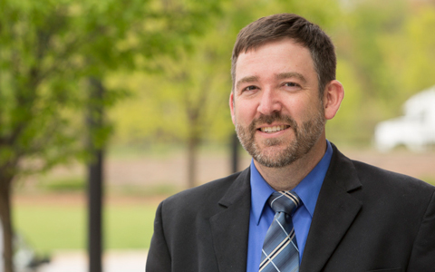 Dave Fenstermacher smiling with a suit and tie.