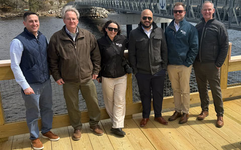 VHB’s project team standing on a new riverside fishing platform.
