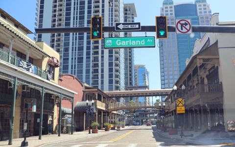 A downtown Orlando intersection with buildings and stoplight. 