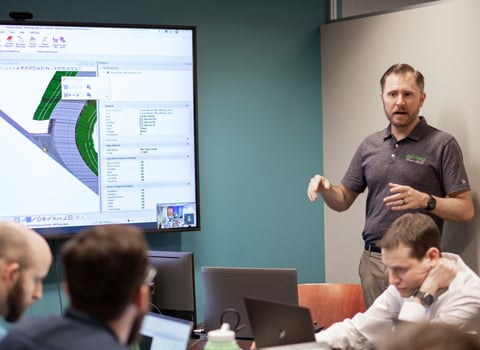 Kyle Rosenmeyer stands during an office presentation.