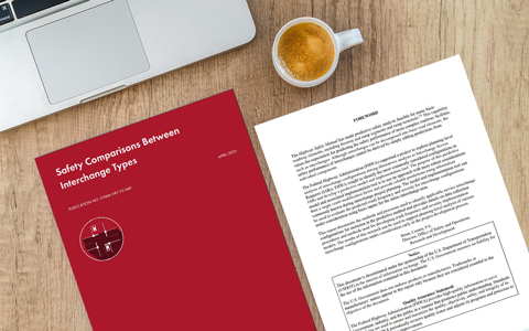 The red front cover of the Safety Comparisons Between Interchange Types publication and Foreword printed out on a desk.