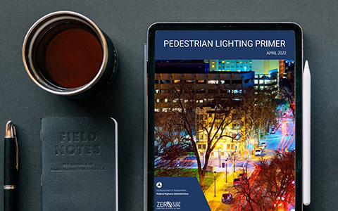 A tablet on a table displaying the Pedestrian Lighting Primer report cover.