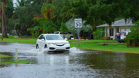 Image of SUV driving through flooded street