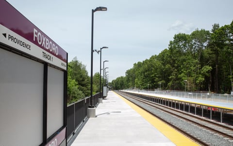 Foxboro Station platform with an MBTA train.