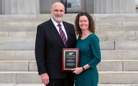 Jenn Conley accepts an award from the Vermont Secretary of Transportation.