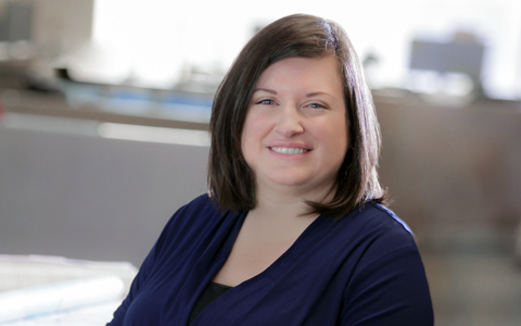 Jen McGovern sitting down wearing a navy-blue shirt.