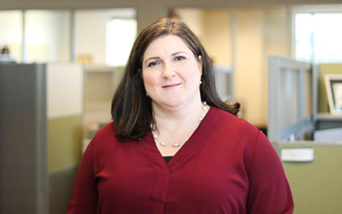 Jenny Fleming in office wearing a red shirt