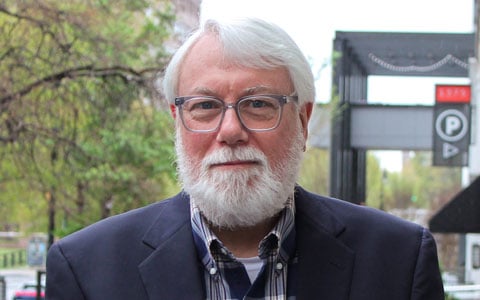 John Fish smiling at the camera.