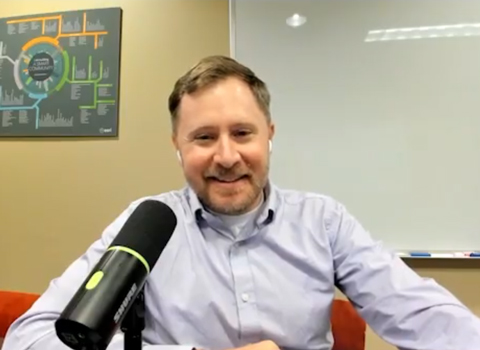 Kyle Rosenmeyer smiles in an outdoor office setting.