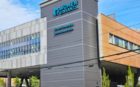 Glass and brick building with Women and Infants sign.