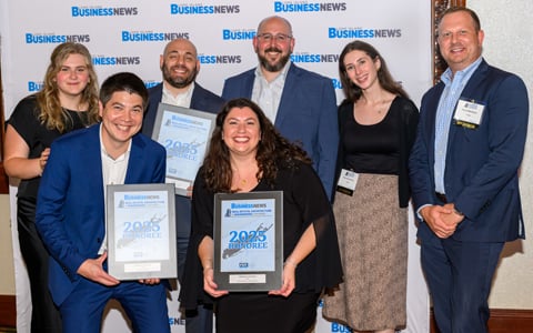 VHB employees smiling while holding awards.