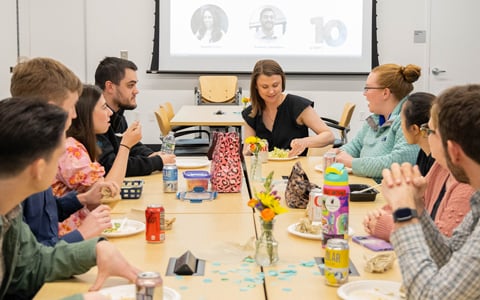 Employees gathered at a VHB Milestones celebration recognizing service anniversaries.
