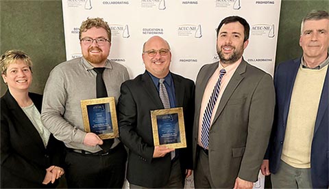 Award winners smiling at the camera