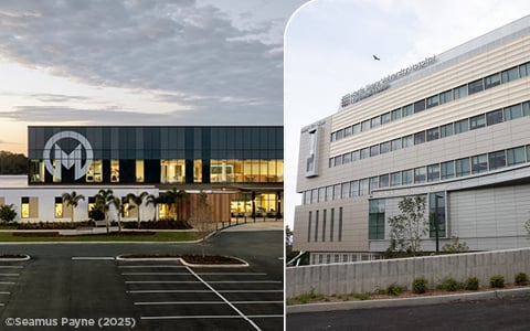 A healthcare building with an M on its exterior facade at sunset.