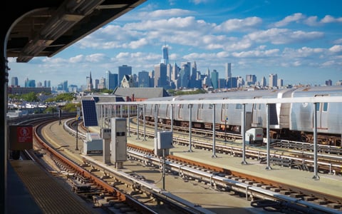 New York City subway on outside tracks during the day.